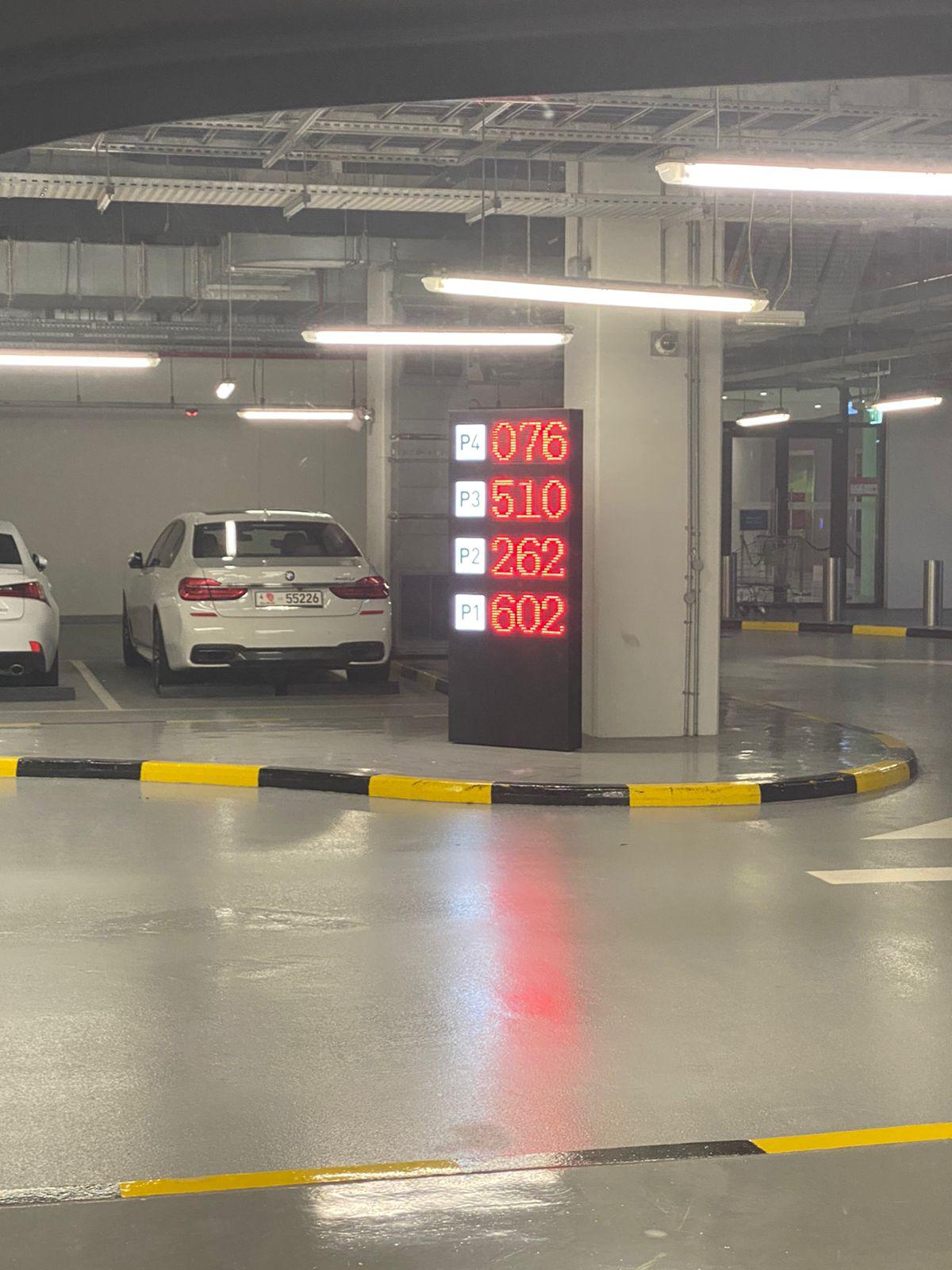 Parking guidance system - indoor floor-level count display tower showing all 4 levels simultaneously